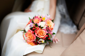Obraz na płótnie Canvas Bride holding floral bouquet