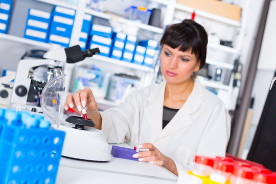 woman in a laboratory with microtube test tube  in hand and PCR