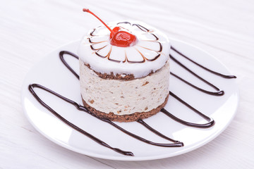 cherry cupcake on white wooden table
