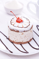 cherry cupcake on white wooden table