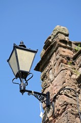 Fototapeta na wymiar Iron lantern on stone wall © Arena Photo UK
