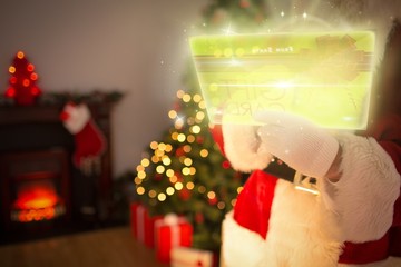 Composite image of santa using futuristic touchscreen