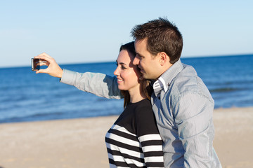 Young couple taking selfie at the beach