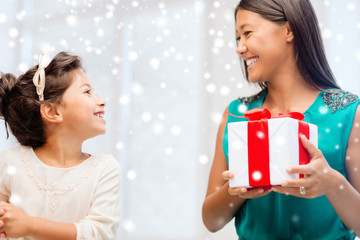 happy mother and child girl with gift box