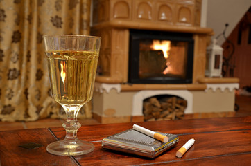 Glass of white wine, cigarettes and snuffbox