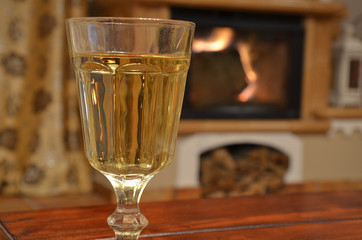 Glass of white wine on wooden table