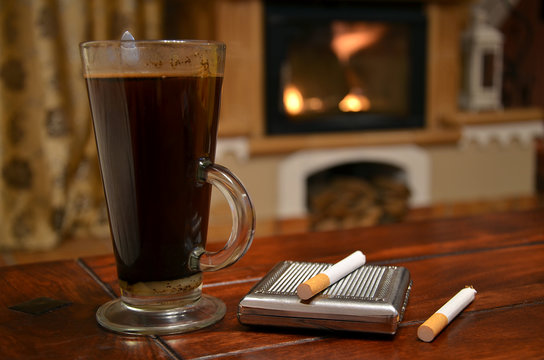Cup of coffee, cigarette and snuffbox