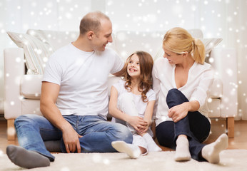 smiling parents and little girl at home