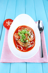 Fresh prawns with spaghetti and lettuce in tomato sauce in a