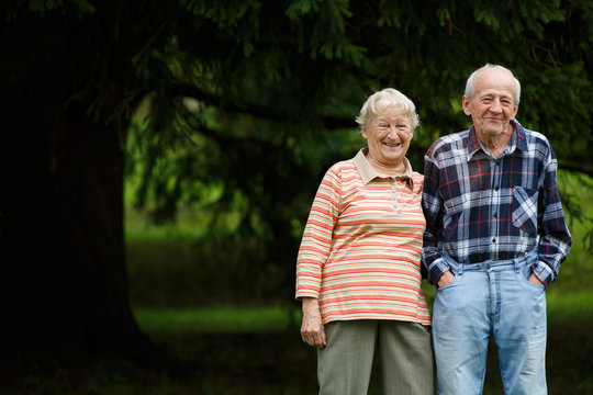 Happy senior couple looking at camera and laughing