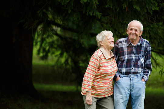 Happy senior couple looking at camera and laughing