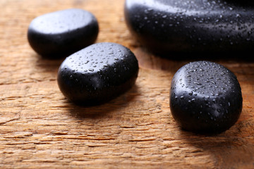 Obraz na płótnie Canvas Spa stones with drops on wooden background