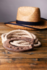 American West still life with old horseshoe, hat and cowboy