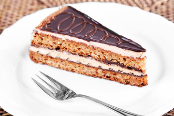 Delicious chocolate cake on plate on table close-up