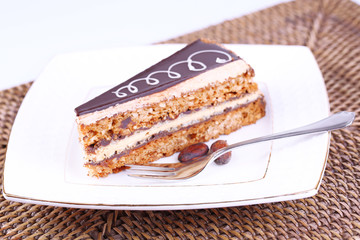 Delicious chocolate cake on plate on table close-up
