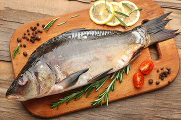 Fresh raw fish and food ingredients on table