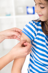 Nurse  putting a plaster over the wound