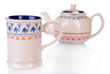 Cup of tea with teapot isolated on white