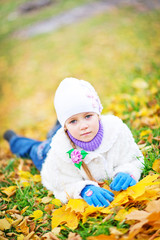 little girl in autumn forest, yellow leaves and little girl