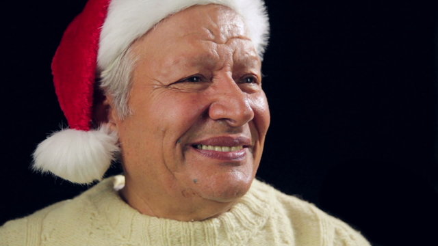Happy Aged Man Offering A Small Red Wrapped Gift