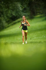 Young lady running. Woman runner running through the park - 73318079