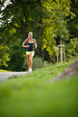 Young lady running. Woman runner running through thepark - 73318465