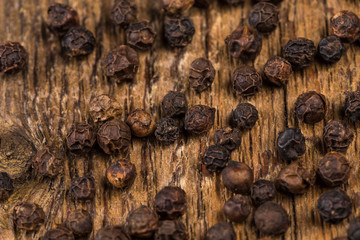 black pepper on wooden table