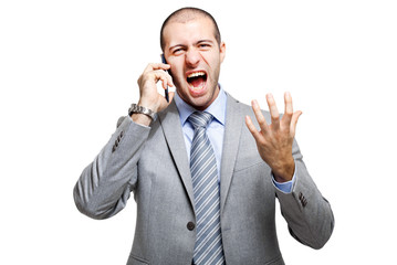 Angry business man screaming on mobile phone