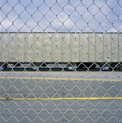 Train car through a chain link fence