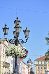 forged lamppost with old town background