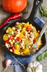 Stew from pumpkin,beans and ground meat with rosemary.