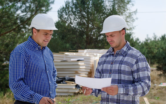 Two engineers having a discussion on site