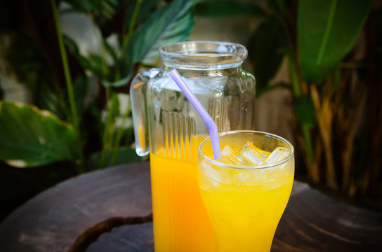 orange juice in a glass and jug