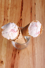 ice cream cone in a  clear glass on wooden background