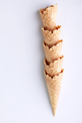 row of ice cream cones on white background