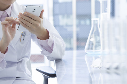Women who are using a mobile phone at the laboratory