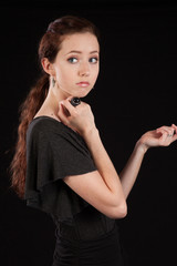 Woman in black dress looking thoughtful