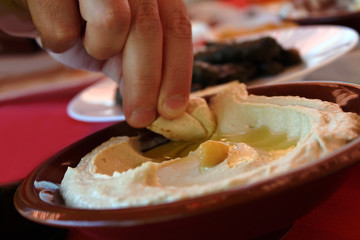 Eating Hummus with Pita Bread