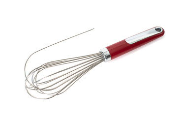 Broken metallic whisk or egg beater on white background