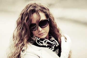 Sad fashion woman in sunglasses outdoor