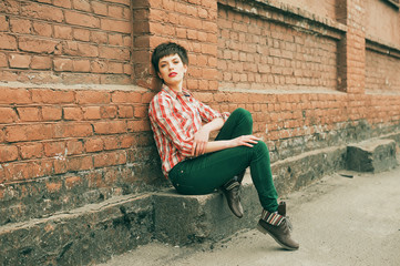 Fototapeta na wymiar Woman wearing checkered shirt and jeans. Short hair