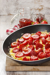 Strawberry omelette on frying pan