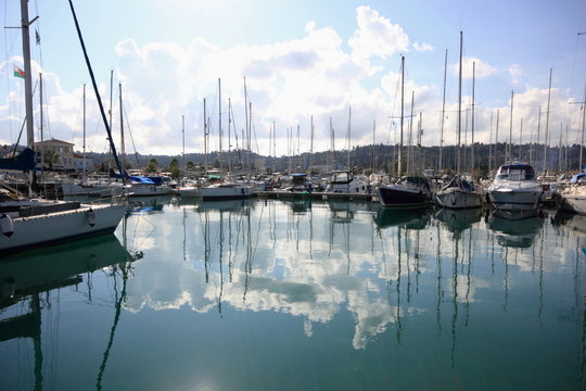 yacht and boat reflections in marina harbour	