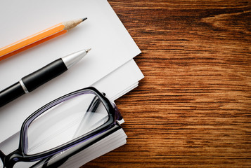 Fototapeta premium Conceptual Supplies and Glasses on Wooden Table