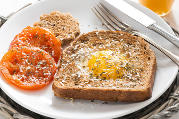fried egg and tomatoes in a toast for breakfast