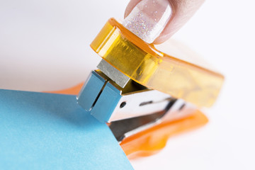 orange office stapeler and blue cardboard