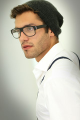 Trendy guy with suspenders and eyeglasses, isolated