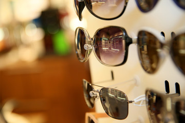 Closeup of sunglasses set on display unit in optical store