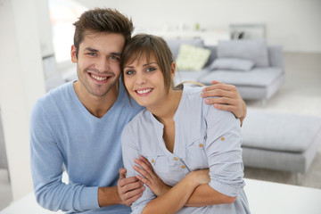 Happy young couple moving together in new apartment