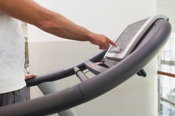 Fit man working out on treadmill